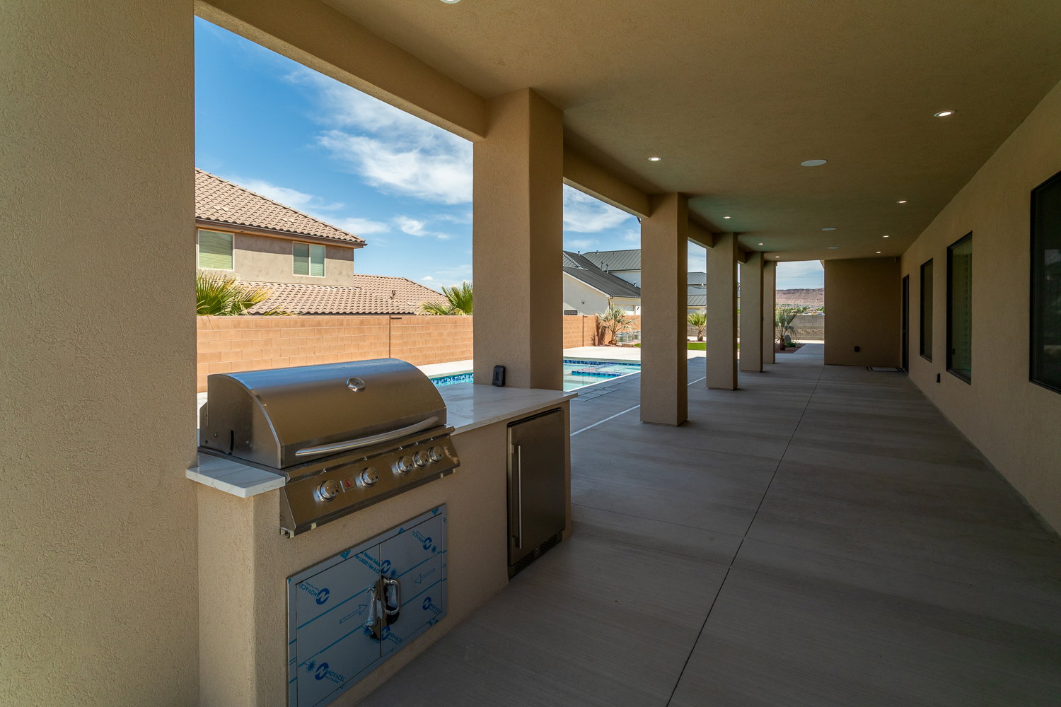 View of patio / terrace featuring grilling area, an outdoor kitchen, a fenced in pool, and fence private yard