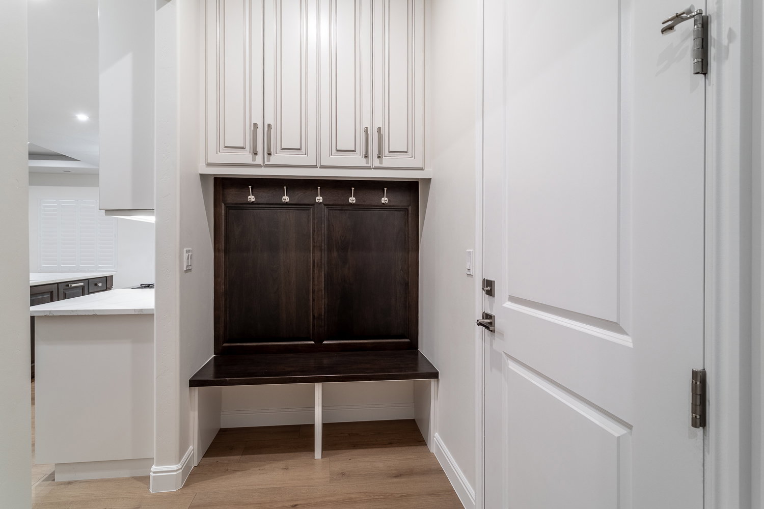 Mudroom featuring light wood finished floors and baseboards