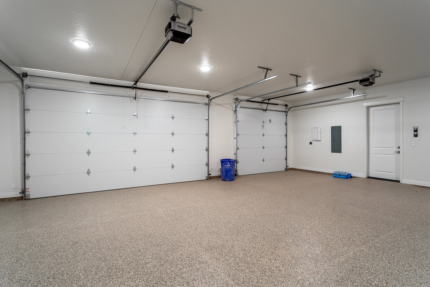 Garage with electric panel and a garage door opener