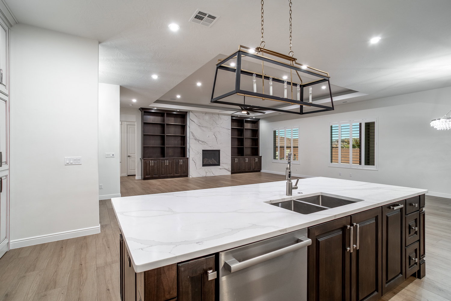Kitchen with visible vents, dishwasher, a sink, open floor plan, and recessed lighting
