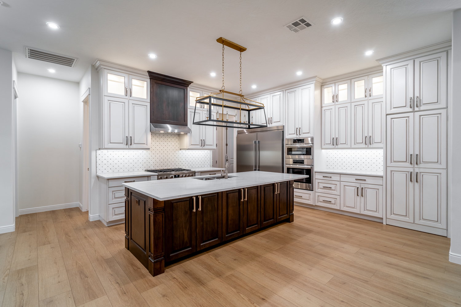 Kitchen with a sink, light countertops, visible vents, and stainless steel appliances