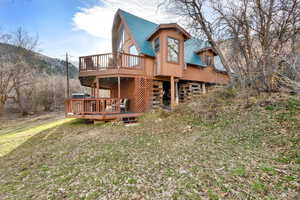 East  view of property with a gambrel roof and a deck