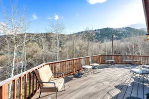 Upper Wooden terrace featuring a mountain view