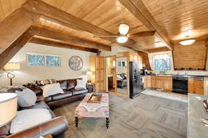 Living room with light carpet, beamed ceiling, wooden ceiling, and ceiling fan