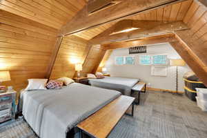 Upper loft Bedroom with wooden ceiling, lofted ceiling with beams, and cooling unit