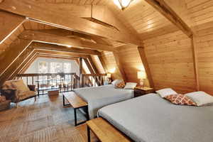 Upper Loft Bedroom area with wood walls, wood ceiling, and vaulted ceiling with beams
