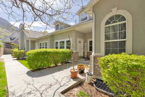 Exterior space featuring stucco siding and fence