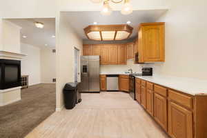 Kitchen featuring a sink, light countertops, light wood-type flooring, recessed lighting, and stainless steel appliances