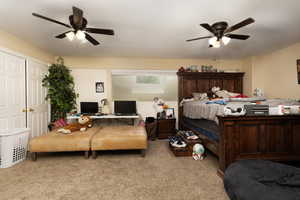 Bedroom featuring ceiling fan and carpet flooring
