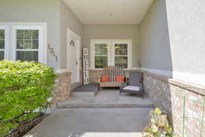View of exterior entry featuring stucco siding and stone siding