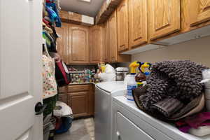 Clothes washing area with cabinet space and washing machine and clothes dryer