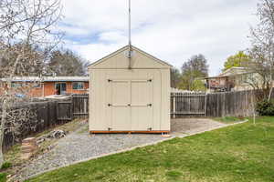 View of shed featuring a fenced backyard