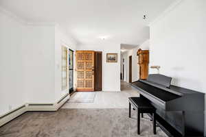 Entrance foyer featuring ornamental molding and light wood-type flooring