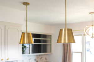 Room details featuring white cabinets and a chandelier