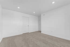Spare room with recessed lighting, baseboards, and carpet floors