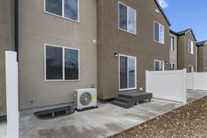 Back of property with ac unit, fence, a patio, and stucco siding