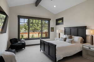 Bedroom with light colored carpet and baseboards