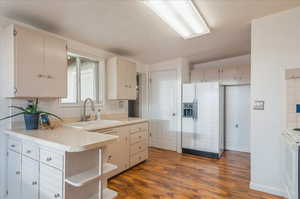 Kitchen with a sink, tasteful backsplash, open shelves, and white appliances