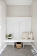 Mudroom with visible vents, baseboards, and light tile patterned flooring