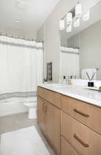 Full bath featuring toilet, a shower with shower curtain, tile patterned flooring, and vanity