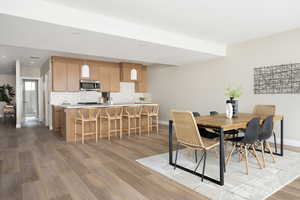 Dining room with recessed lighting, light wood finished floors, visible vents, and baseboards