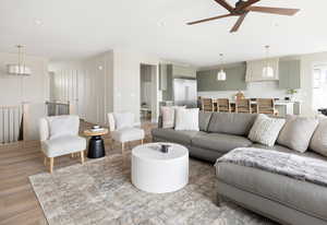 Living room featuring recessed lighting, light wood-type flooring, and ceiling fan