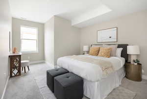 Bedroom featuring light carpet and baseboards
