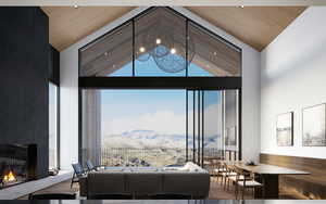 Living room featuring high vaulted ceiling, a glass covered fireplace, wood finished floors, wooden ceiling, and a mountain view