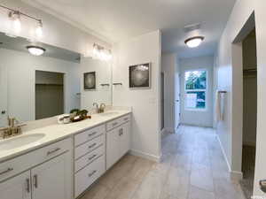 Full bath featuring a sink, a spacious closet, double vanity, ( upgraded NOT EXACT HOME MODEL OF BRIDGER PLAN