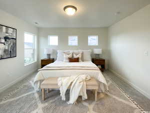 NOT exact home MOdel of bridger plan Bedroom with light colored carpet, baseboards, and visible vents