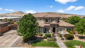 Mediterranean / spanish home with stucco siding, a gate, a mountain view, fence, and a tiled roof