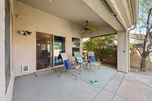 View of patio featuring fence and ceiling fan