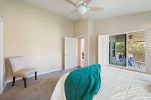 Carpeted bedroom with access to outside, baseboards, and a ceiling fan