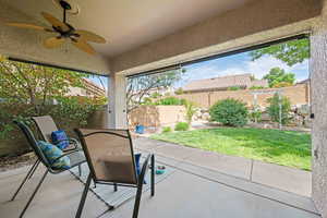 View of patio / terrace with ceiling fan and a fenced backyard
