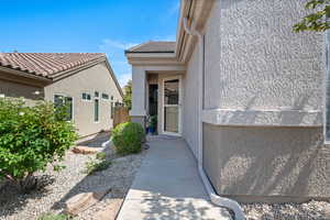 Property entrance featuring stucco siding