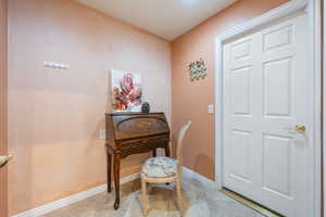 Office space featuring light tile patterned floors and baseboards