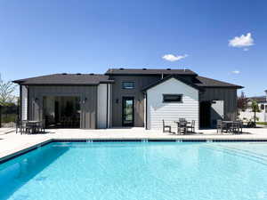 Community pool featuring fence and a patio  NOT EXACT CLUBHOUSE