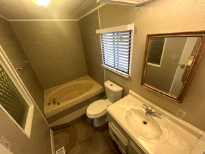 Bathroom with toilet, visible vents, tile patterned floors, and vanity
