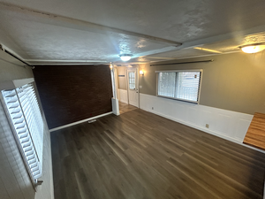 Empty room with wainscoting and wood finished floors