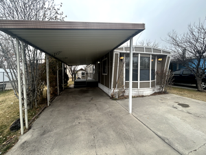 View of car parking featuring a carport and driveway