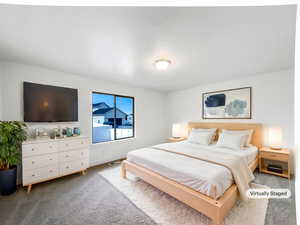 Bedroom featuring baseboards, visible vents, and carpet floors