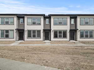 View of property featuring stucco siding