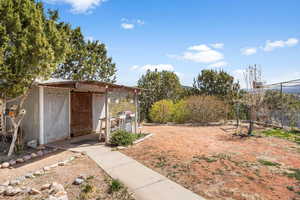 View of yard featuring fence and an outdoor structure
