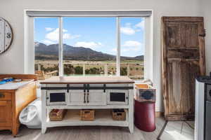 Interior space with a wealth of natural light, a mountain view, and wood finished floors