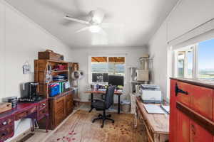 Office area with light wood-style floors, crown molding, and a ceiling fan