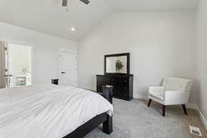 Carpeted bedroom with high vaulted ceiling, visible vents, baseboards, and ceiling fan