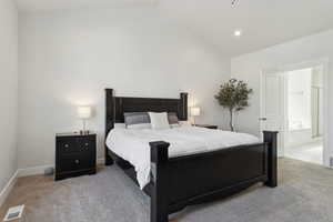 Carpeted bedroom featuring baseboards, lofted ceiling, visible vents, and recessed lighting