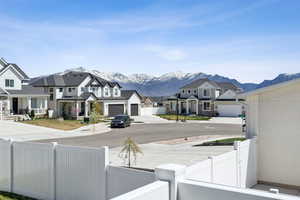 View of street featuring a residential view, a mountain view, and a gate