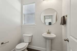 Bathroom featuring toilet and baseboards