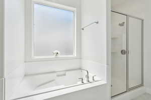 Bathroom with a garden tub and a stall shower